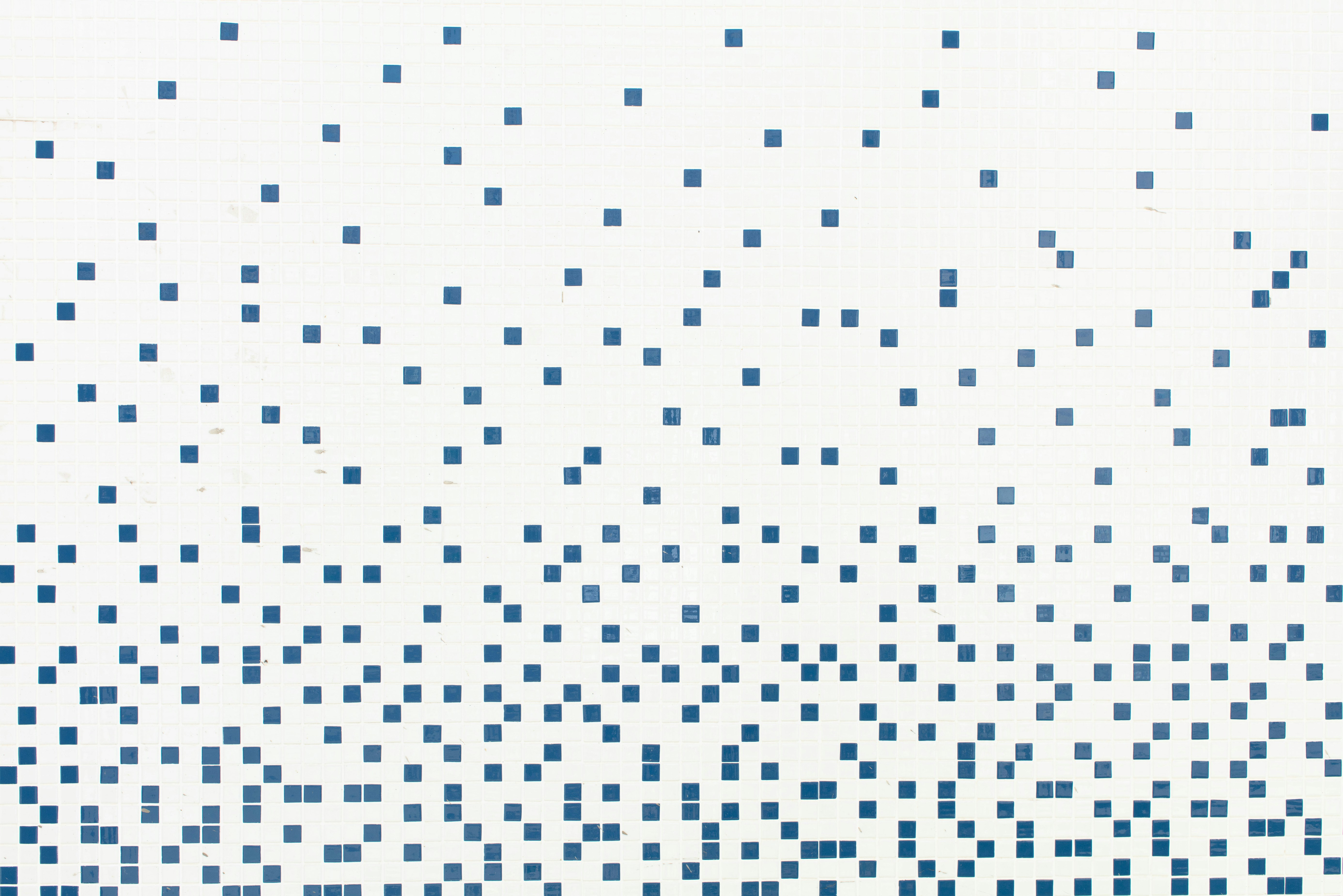 White tile surface with an ordered blue pattern
