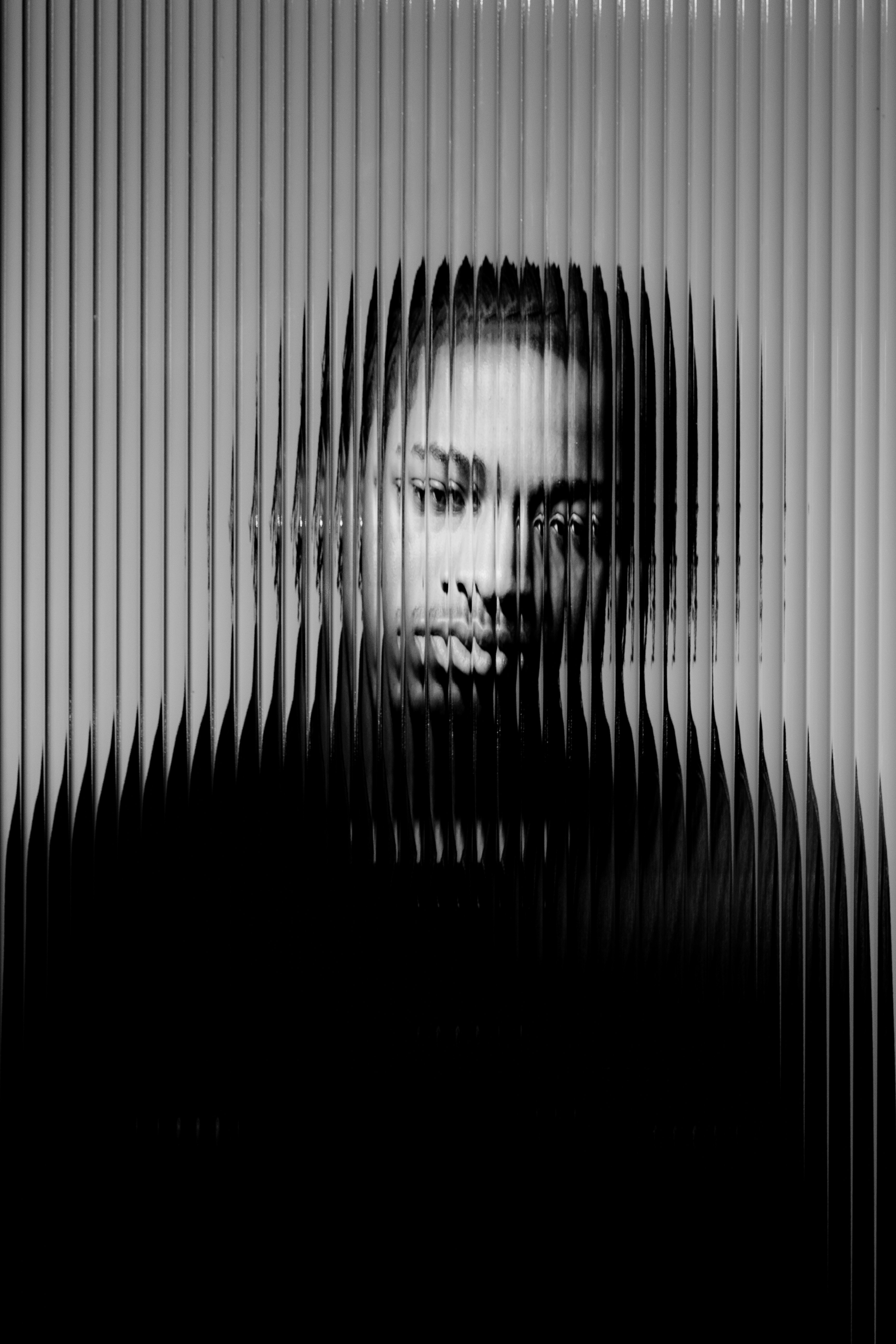 Black and white portrait refracted through glass